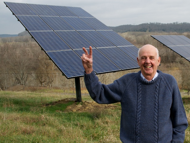 English: Wendell Berry stands before the solar panels on his farm in Henry County, KY. Photo by Guy Mendes